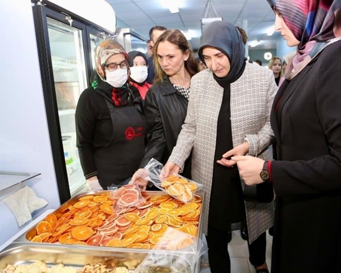 A group of women standing in a line with foodAI-generated content may be incorrect.