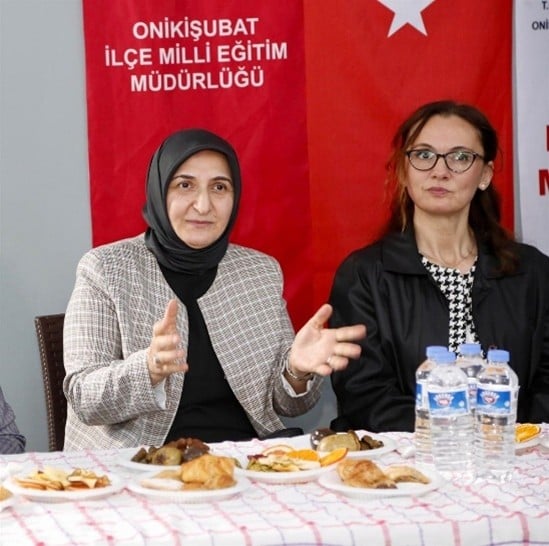 A group of women sitting at a table with foodAI-generated content may be incorrect.