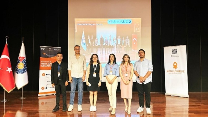 A group of people standing on a stageAI-generated content may be incorrect.