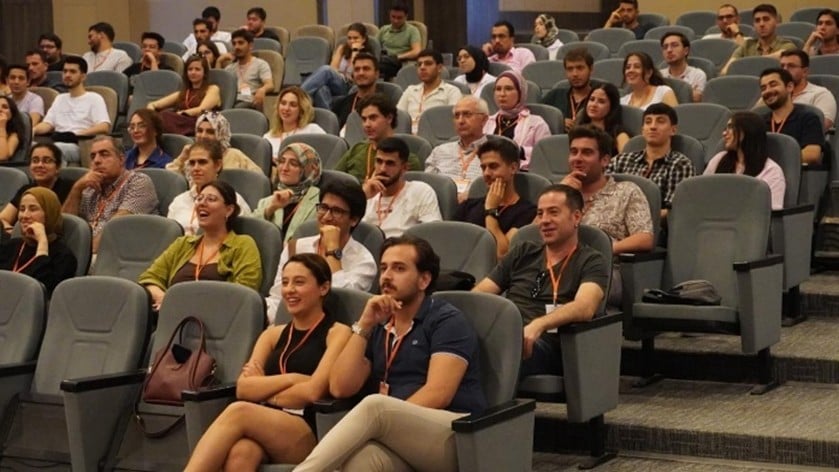 A person standing in front of a large screen